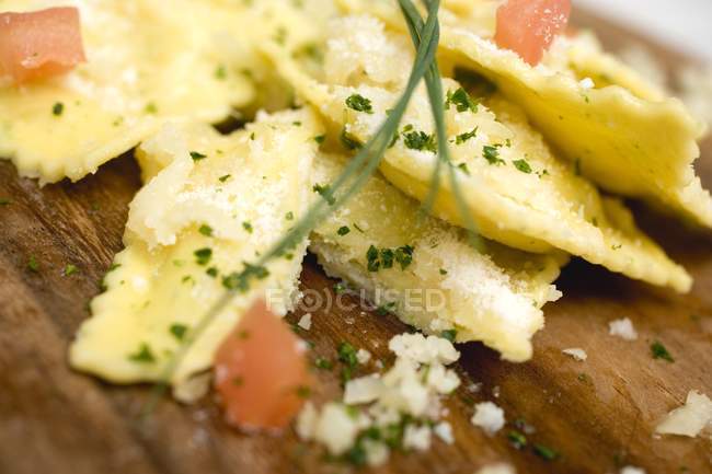 Ravioli pasta with diced tomatoes and Parmesan — Stock Photo