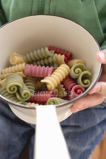 Strainer with coloured pasta — Stock Photo