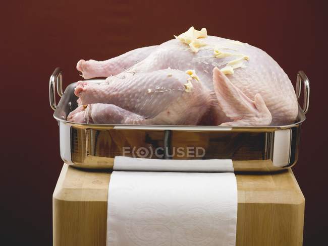 Raw turkey brushed with butter — Stock Photo