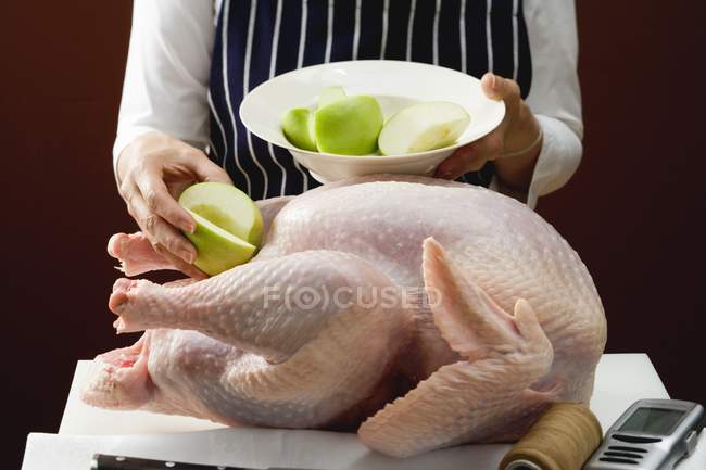Chef Stuffing turkey with apples — Stock Photo