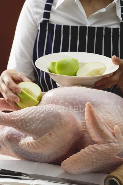 Chef Stuffing turkey with apples — Stock Photo