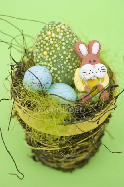 Easter sweets in nest — Stock Photo