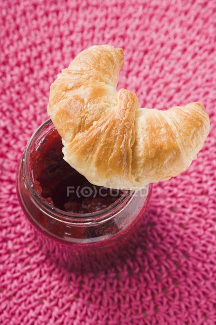 Raspberry jam and croissant — Stock Photo