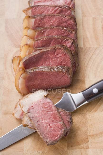 Beef steak with knife — Stock Photo