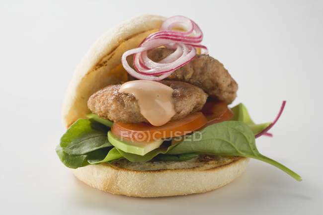 Hamburger con spinaci, avocado, pomodoro e cipolla su fondo bianco — Foto stock