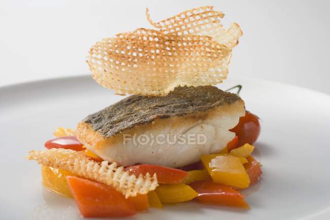 Fried fish fillet on peppers — Stock Photo