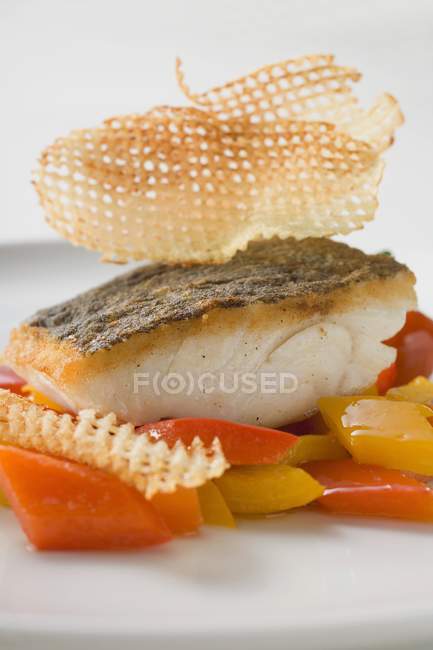 Fried fish fillet on peppers — Stock Photo