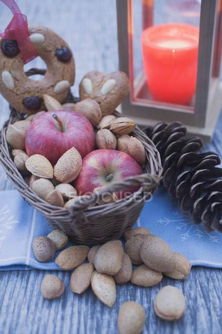 Red apples with almonds and cone — Stock Photo