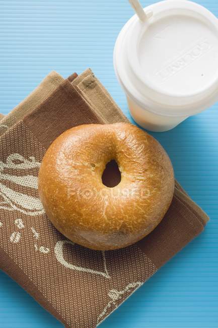 Plain baked Bagel and cup of coffee — Stock Photo