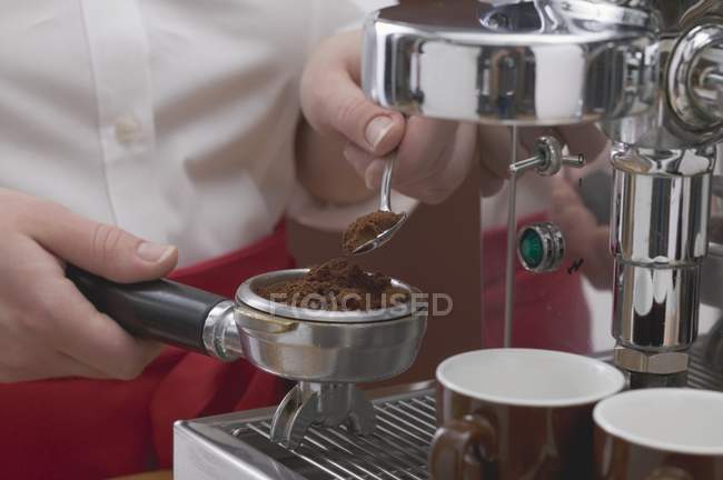 Woman filling filter holder with coffee — Stock Photo