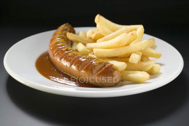 Currywurst with fried potato chips — Stock Photo