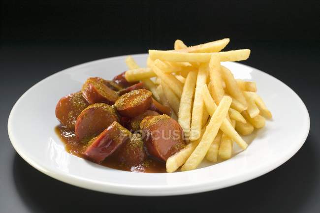 Sausage slices and fried potato chips — Stock Photo