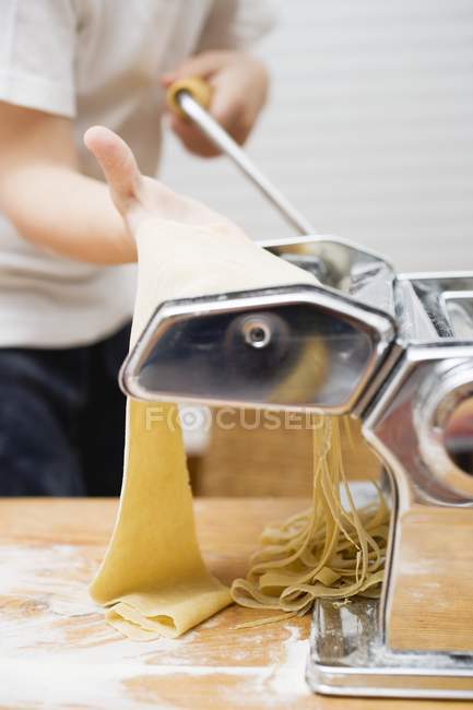 Person making tagliatelle pasta — Stock Photo