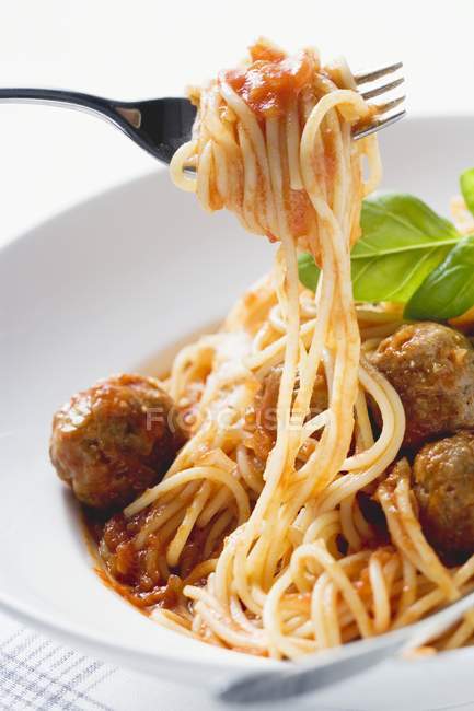 Spaghetti on fork with meatballs — Stock Photo