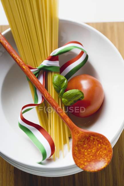 Bundle of dried Spaghetti with ribbon — Stock Photo