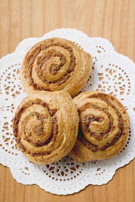 Closeup top view of three Danish pastry swirls with nut filling — Stock Photo