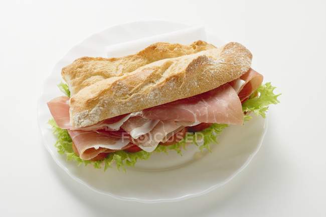 Sandwich with raw ham and vegetables — Stock Photo