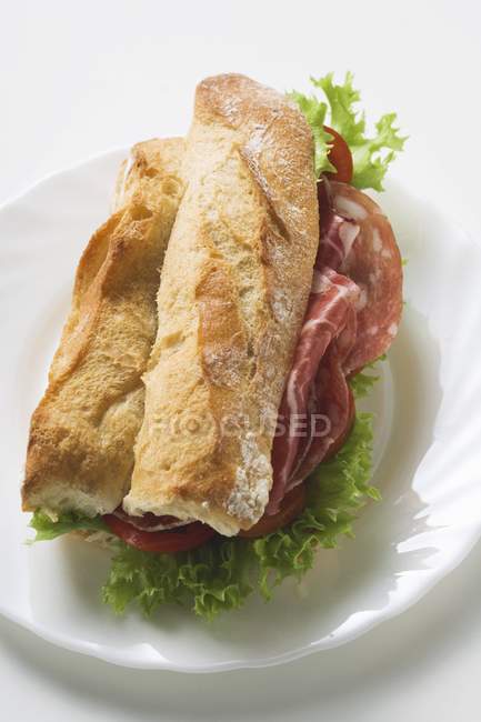 Sandwich with raw ham and lettuce — Stock Photo