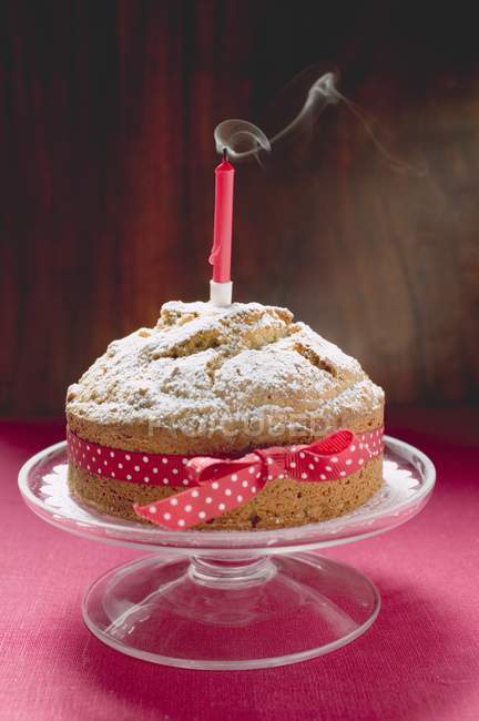 Birthday cake with red bow — Stock Photo