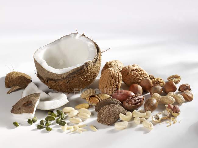 Closeup view of assorted nuts on white surface — Stock Photo