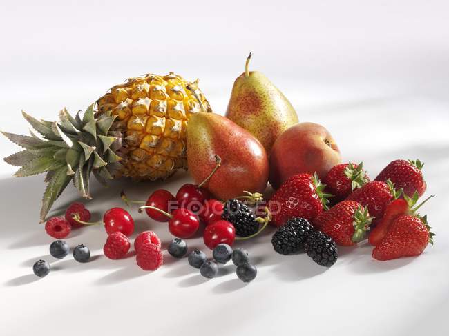 Summer fruits and berries with pineapple — Stock Photo