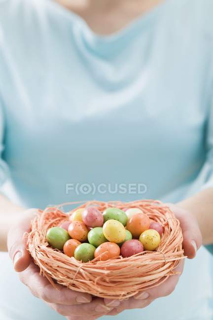 Woman holding Easter nes — Stock Photo