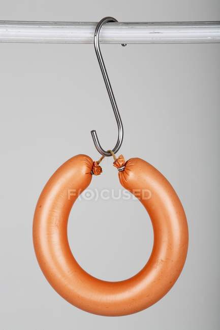 Closeup view of a Ringwurst sausage hanging on a hook — Stock Photo