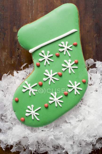 Christmas biscuit in shape of green boot — Stock Photo
