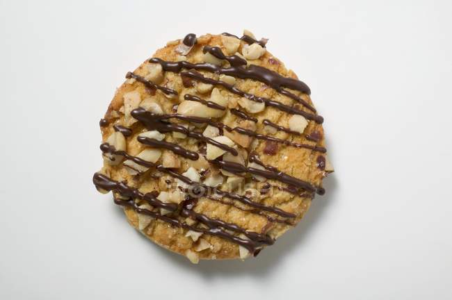 Biscuit with nuts and chocolate drizzle — Stock Photo
