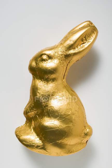 Chocolate bunny in gold foil — Stock Photo
