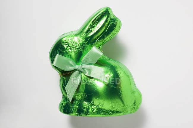 Chocolate bunny in green foil — Stock Photo
