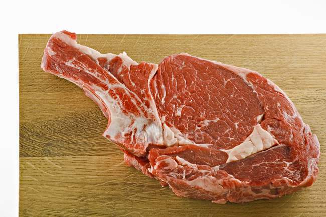 Rib-eye steak on board — Stock Photo