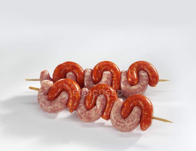 Speared skewered sausages — Stock Photo