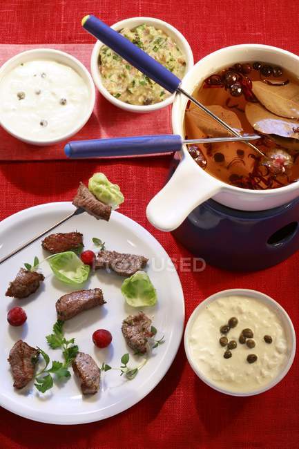 Meat fondue with broth — Stock Photo