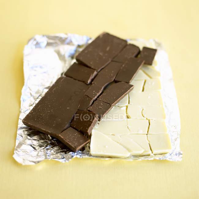 Chocolate bars on aluminium foil — Stock Photo