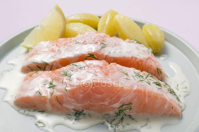 Salmon fillets and boiled potatoes — Stock Photo