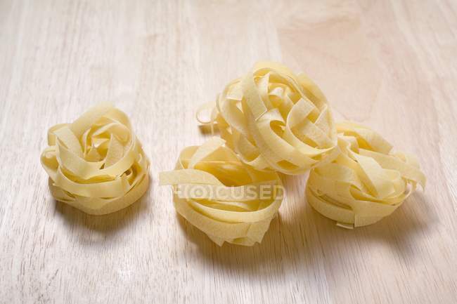Dried tagliatelle pasta nests — Stock Photo