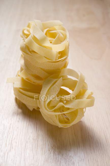 Dried tagliatelle pasta nests — Stock Photo