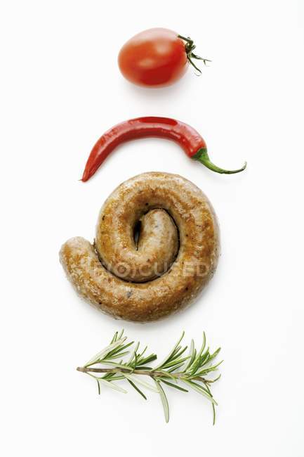 Coiled sausage with rosemary — Stock Photo