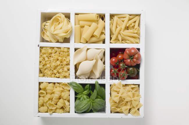 Various types of pasta with tomatoes — Stock Photo
