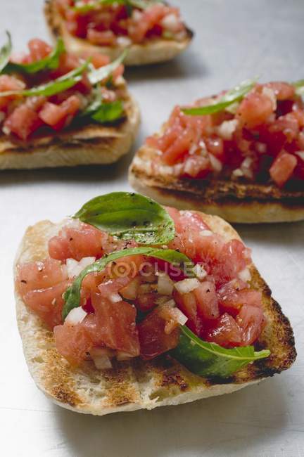 Bruschetta with tomato salsa and basil — Stock Photo