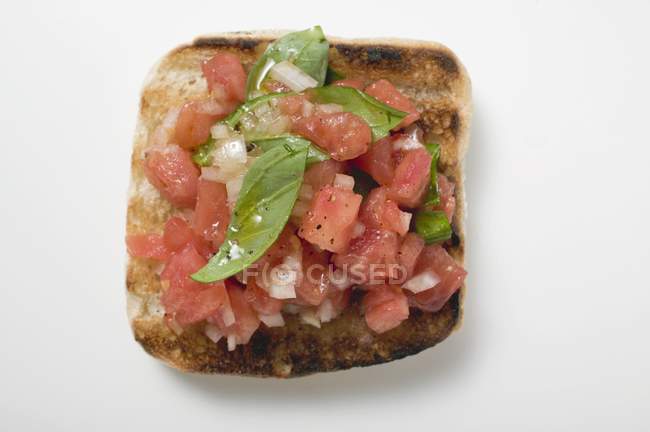 Bruschetta with tomato salsa and basil — Stock Photo