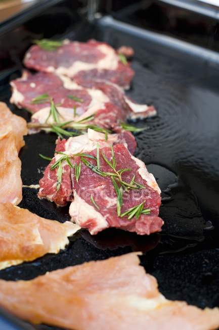 Marinated steaks with herbs — Stock Photo