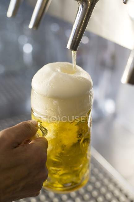 Pouring draught beer — Stock Photo