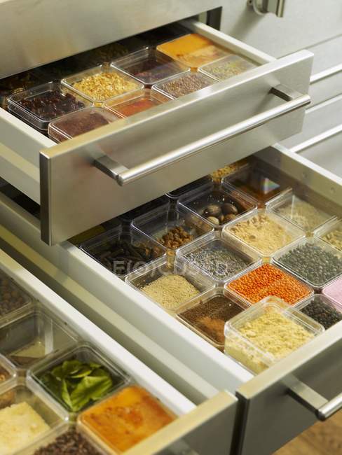 Closeup view of opened spice drawers with boxes of different spices — Stock Photo