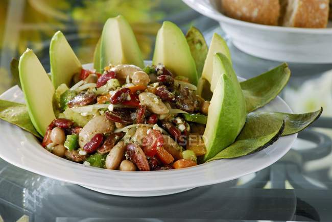 Bean salad with avocado on white plate — Stock Photo