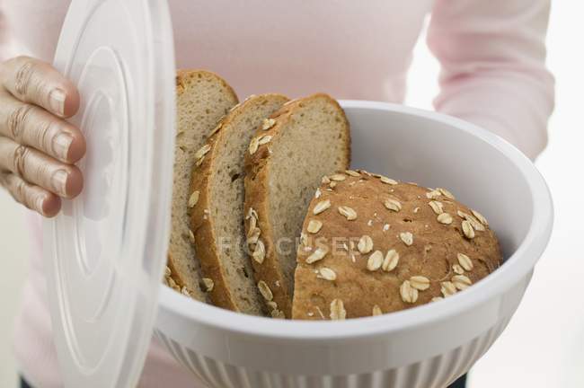 Woman holding oat bread — Stock Photo