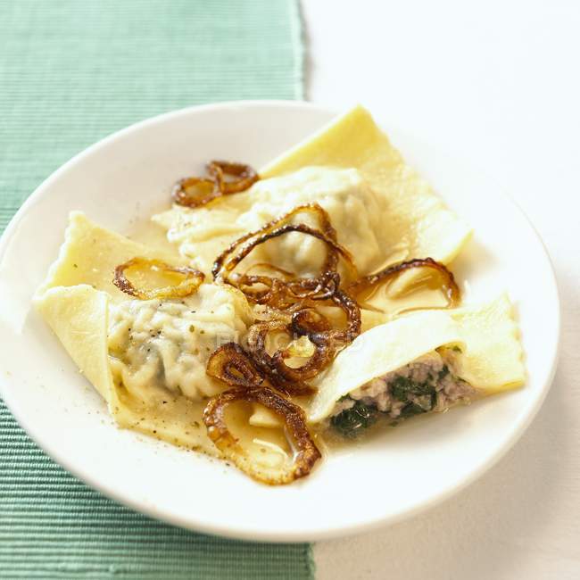Filled pasta parcels with fried onions — Stock Photo