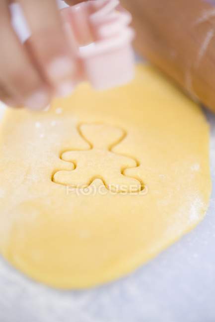 Closeup view of hand cutting out a biscuit — Stock Photo