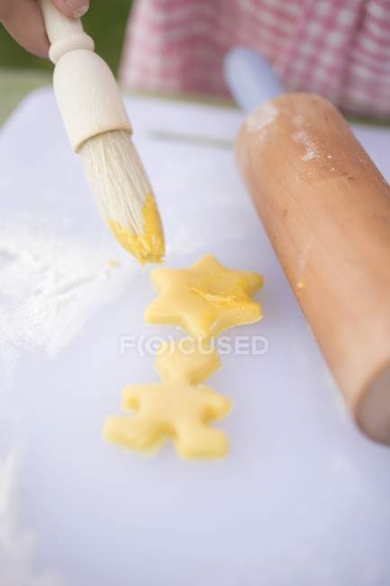 Brushing biscuits with yolk — Stock Photo